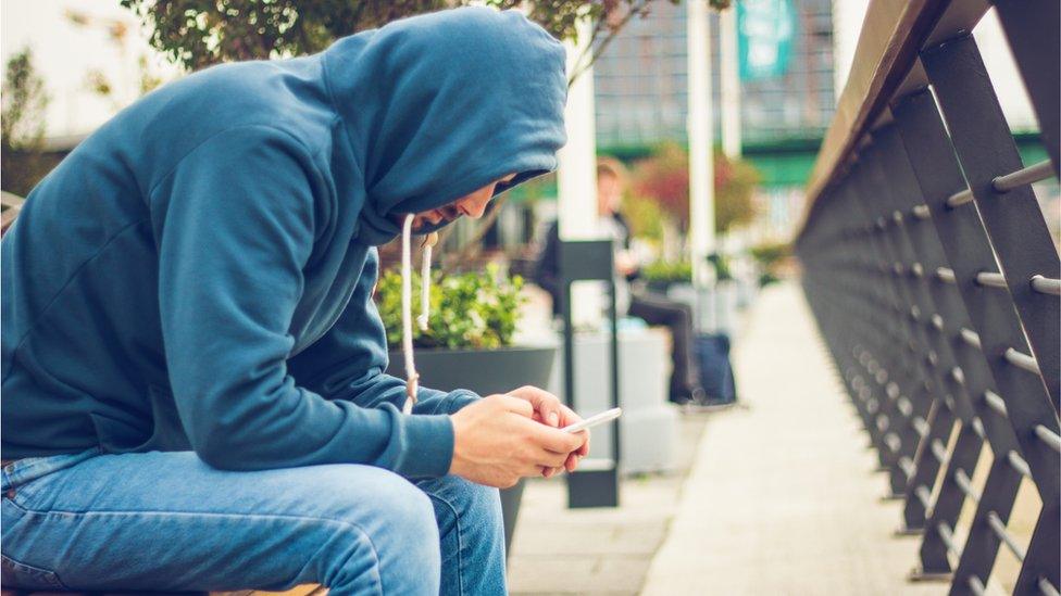 Man sitting on a mobile phone