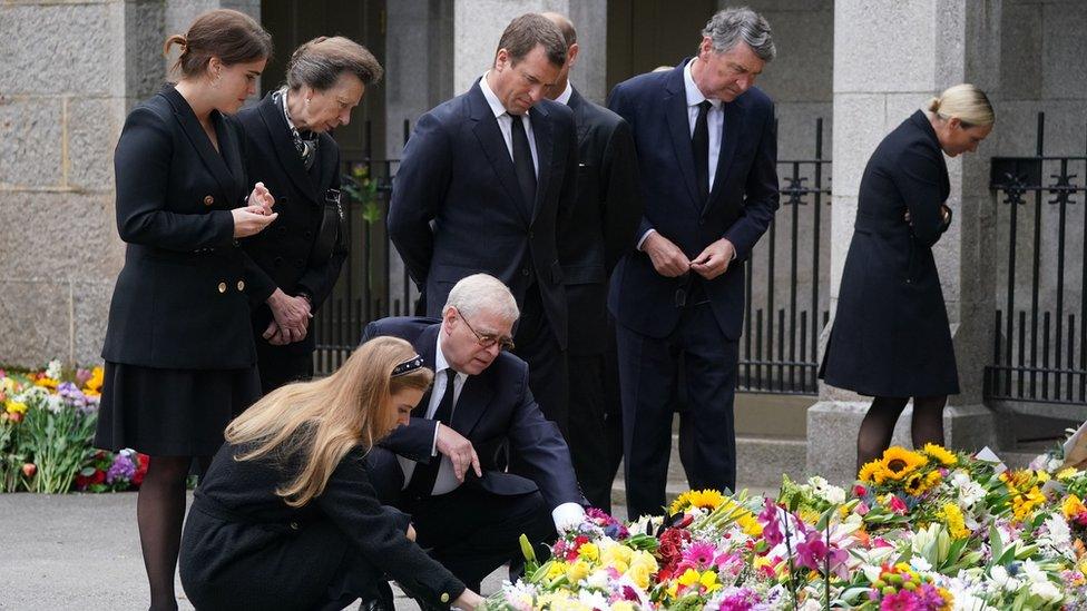 Members of the Royal Family look at tributes outside Balmoral