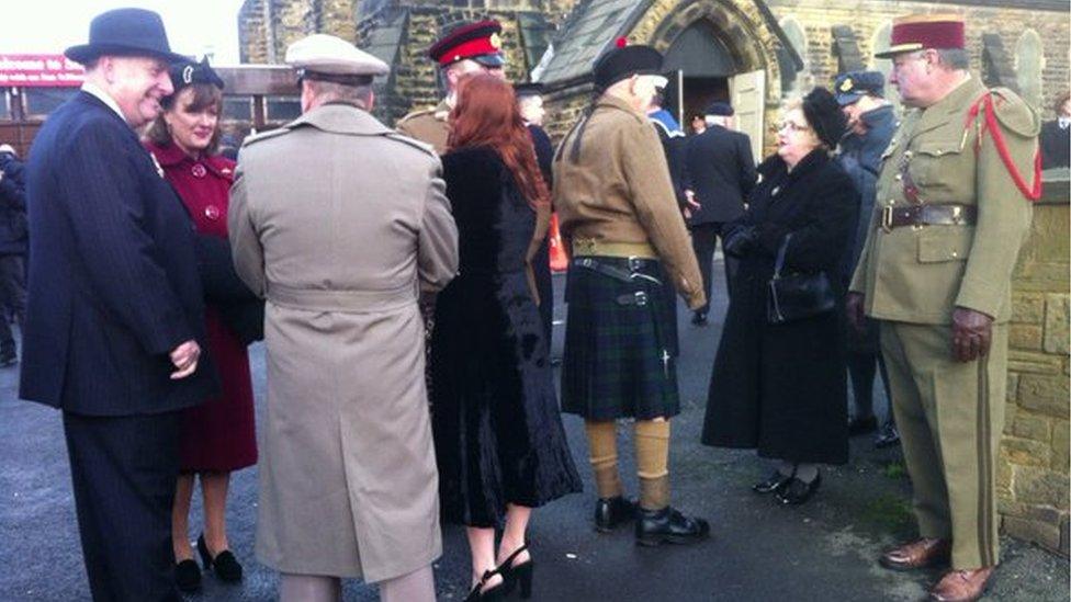 People standing in front of a church