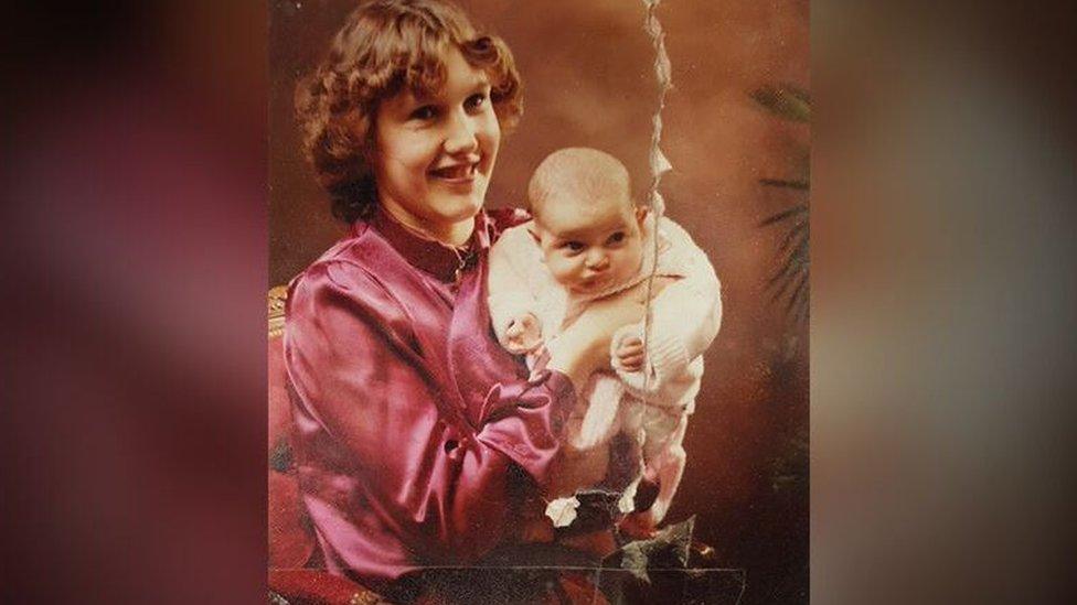 Jackie in the eighties, holding Rahannah as a baby