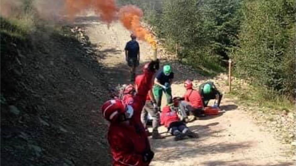 Rescuers attend to the injured cyclist