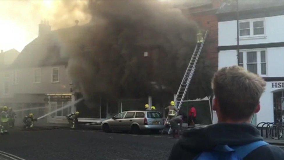 Firefighter on a ladder in Sudbury