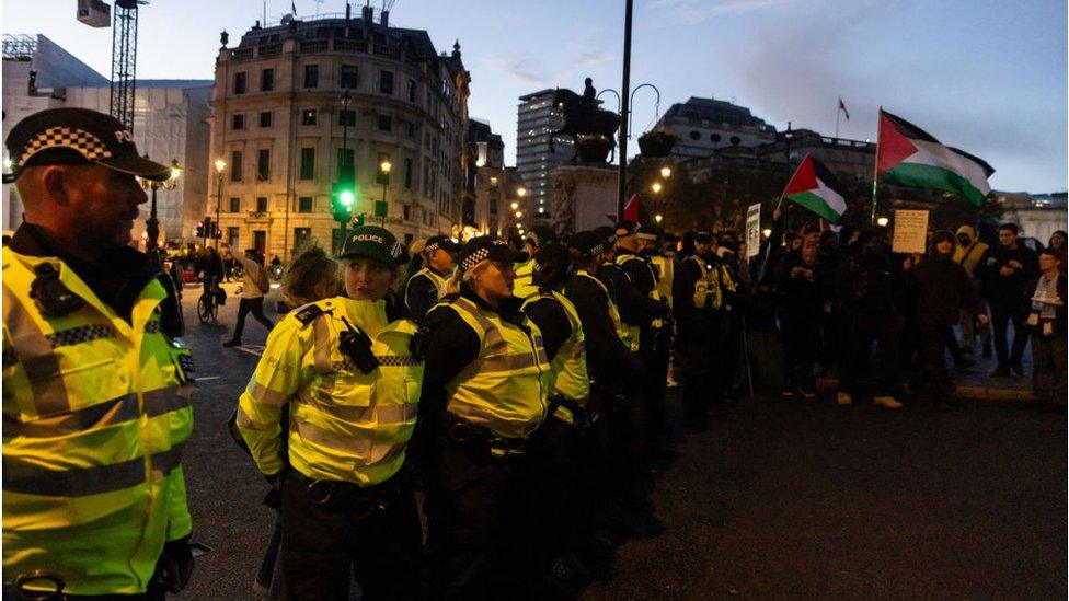 Police stand in a line near pro-Palestinian protesters