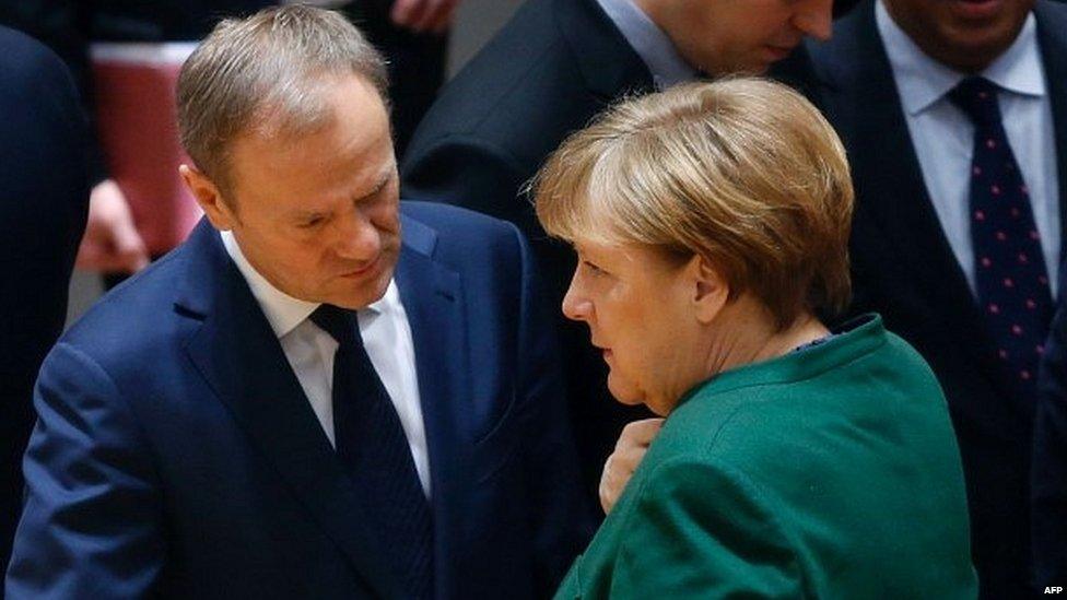 Angela Merkel talking to Donald Tusk