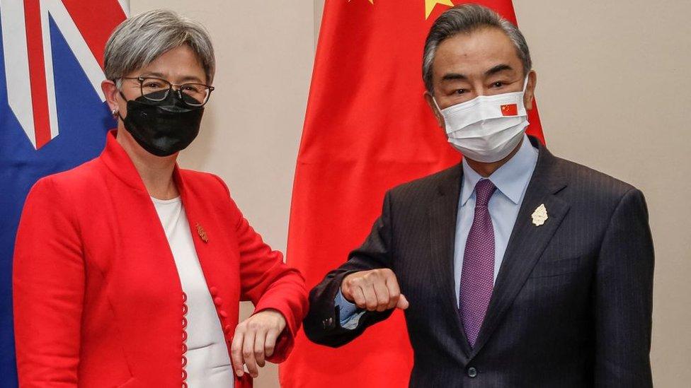 Penny Wong and Wang Yi bump elbows