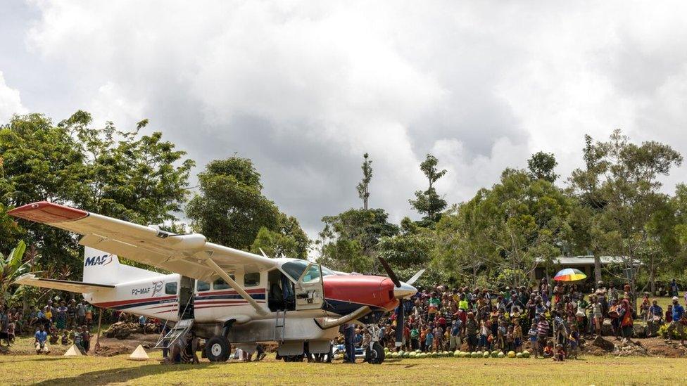 An MAF plane delivering aid