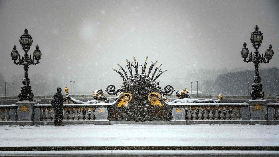 The Alexandre III bridge is pictured as snow falls over Paris on 22 January 2019