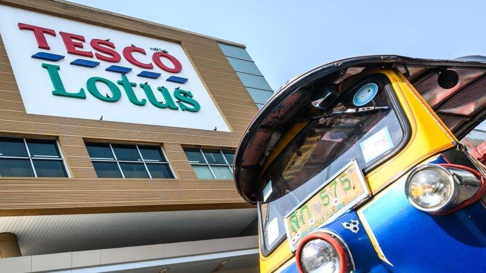 A Thailand's traditional Tuk Tuk waits for customers outside a Tesco-Lotus supermarket in Bangkok.