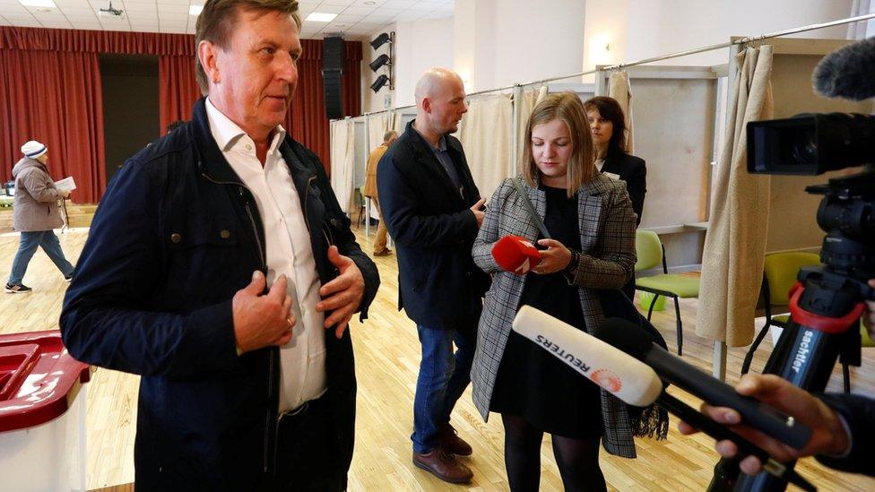 Latvian Prime Minister Maris Kucinskis talks to media after casting his vote during a general election in Ikskile, October 6, 2018