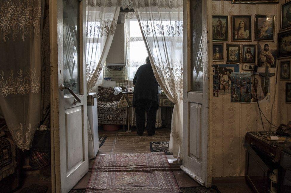 Arusyak prepares coffee in her home