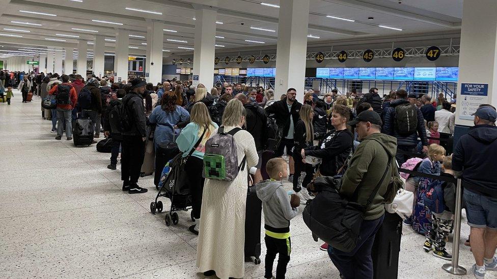 Queuing people at Manchester Airport