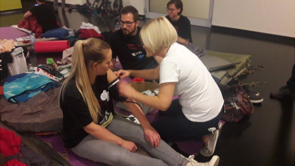 A striking doctor is checked by a volunteer