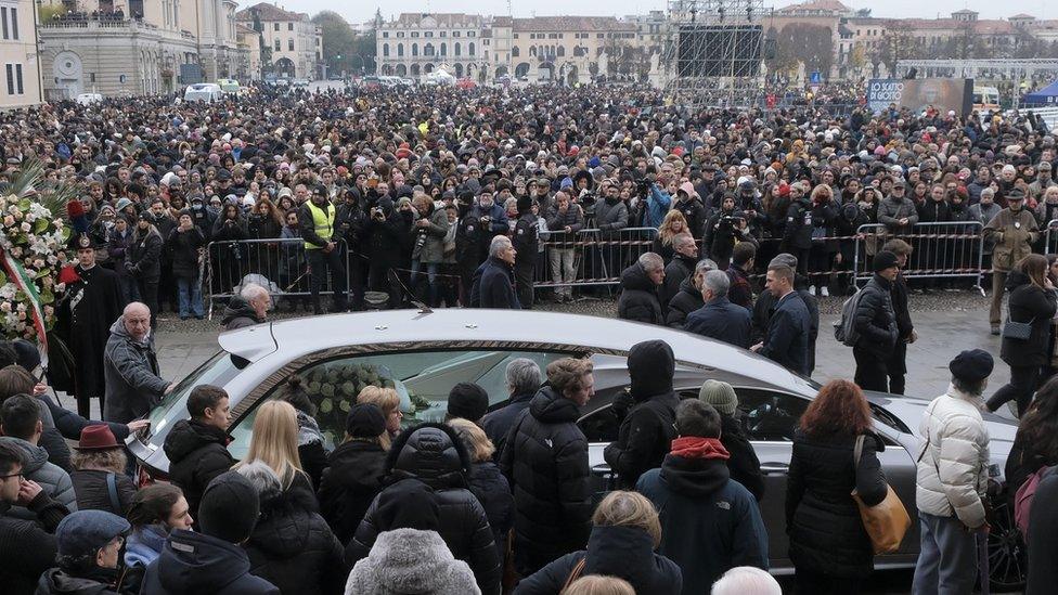 People gather around the hearse carrying the coffin of Giulia Cecchettin after her funeral outside the Santa Giustina Basilica during her funeral in Padua, northern Italy, 05 December 2023. Cecchettin, 22.