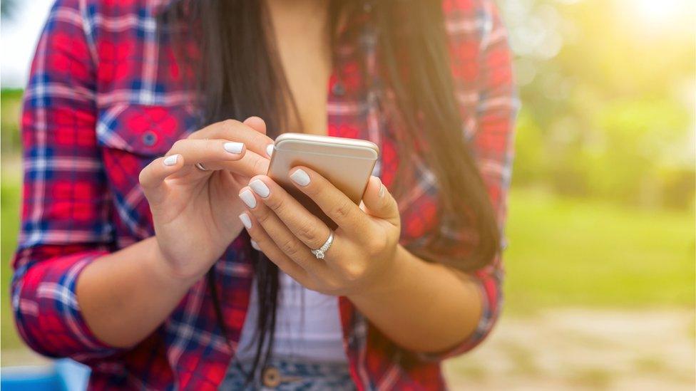 A teenage girl on her mobile phone