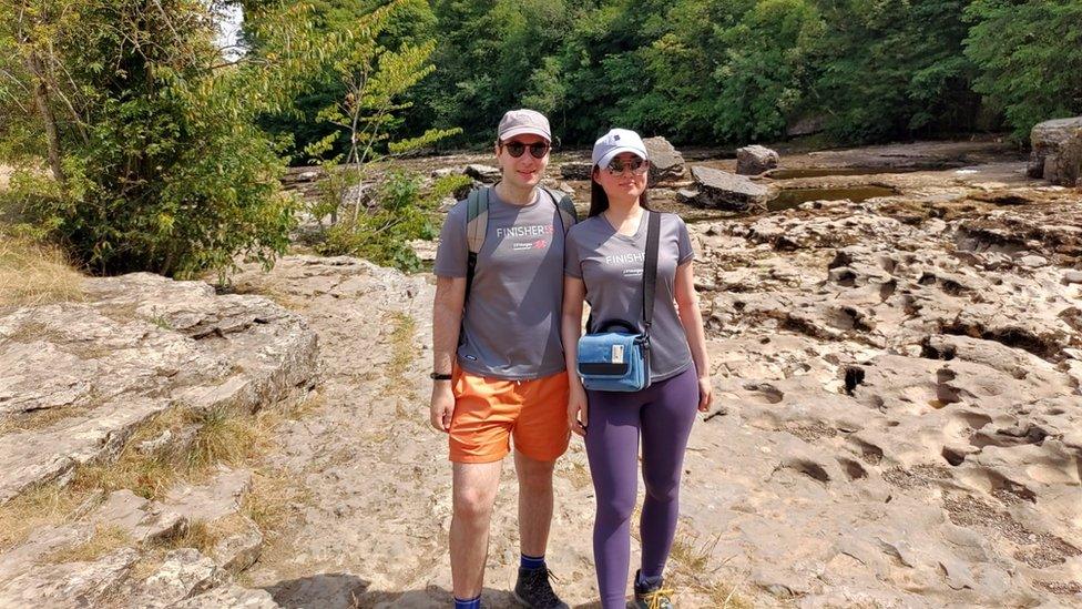 Image of a couple standing on the dried up riverbed