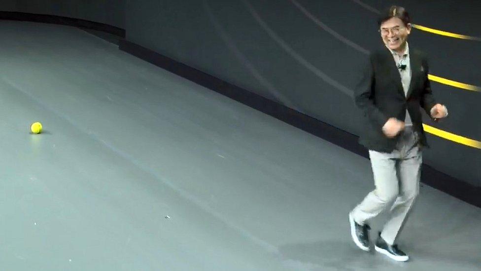 Samsung's president and chief executive is chased on stage by the bot