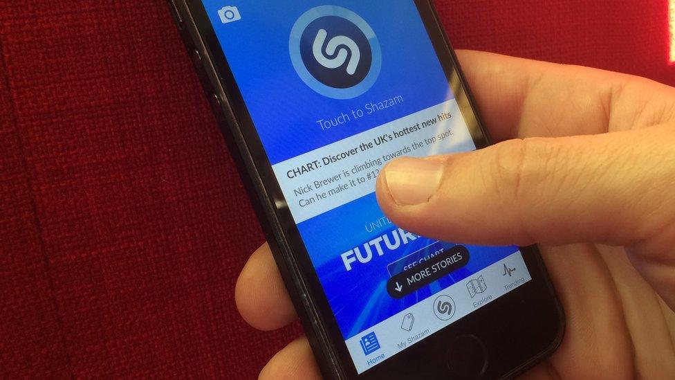 Someone accessing Shazam through a mobile app