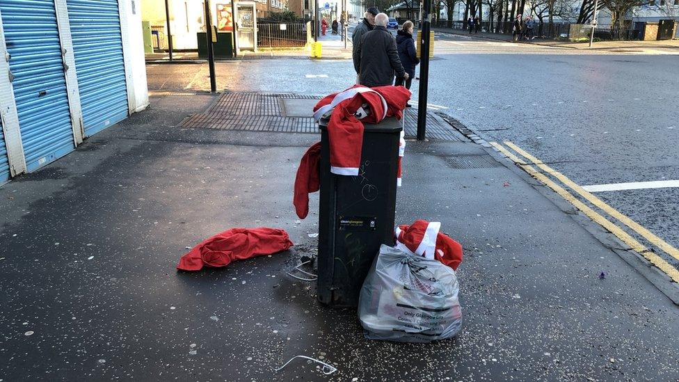 Santa costumes in bin