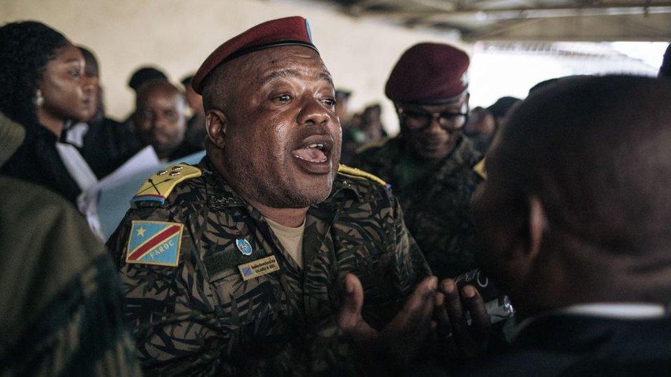 Colonel Mike Mikombe (C), one of the accused Republican Guard officers, argues with a lawyer after the hearing at the military court of Goma, eastern Democratic Republic of Congo, on September 6, 2023.