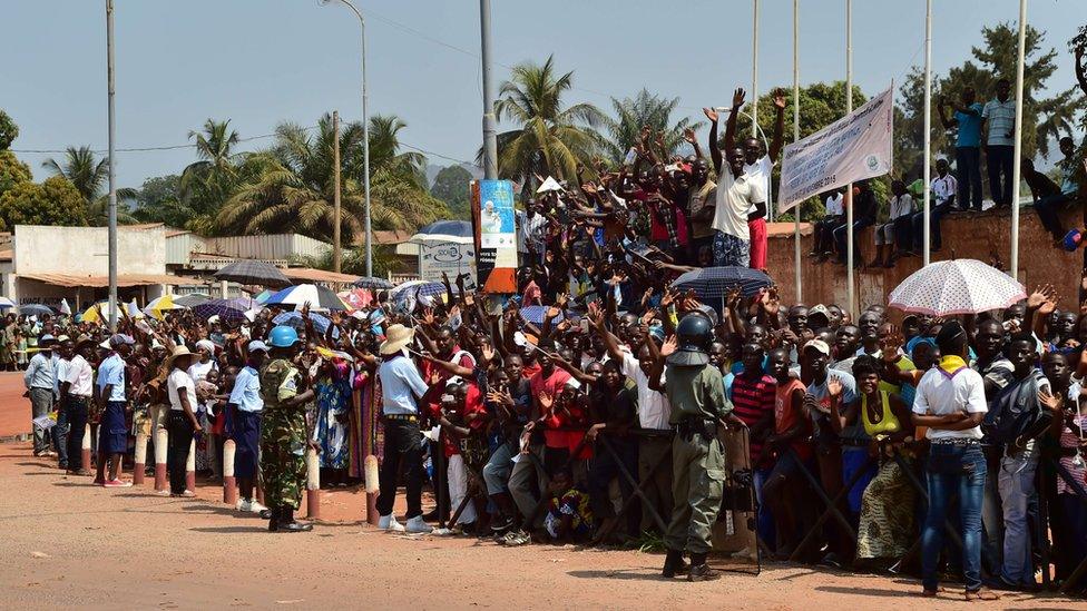 Thousands of people gather on the street to wait for the arrival of Pope Francis in Bangui