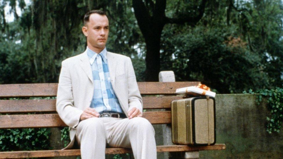 Tom Hanks as Forrest Gump in iconic scene, sitting on bench recounting his life experiences