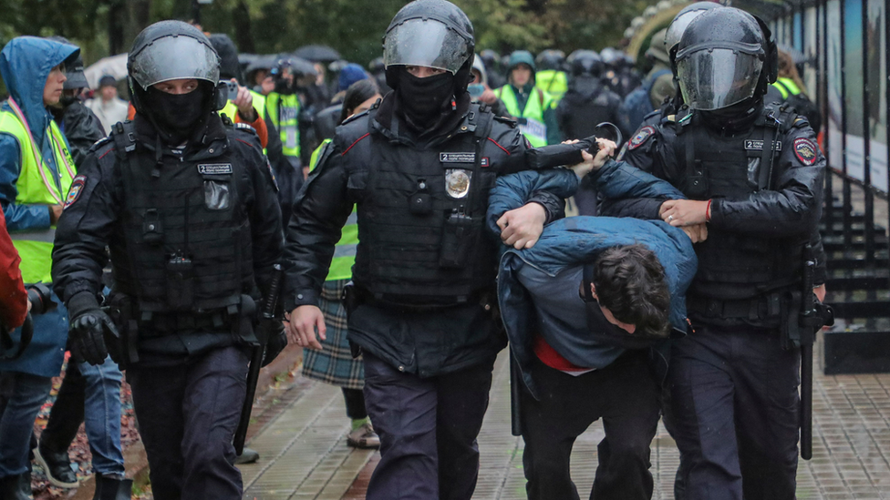 Russian police detain a protester