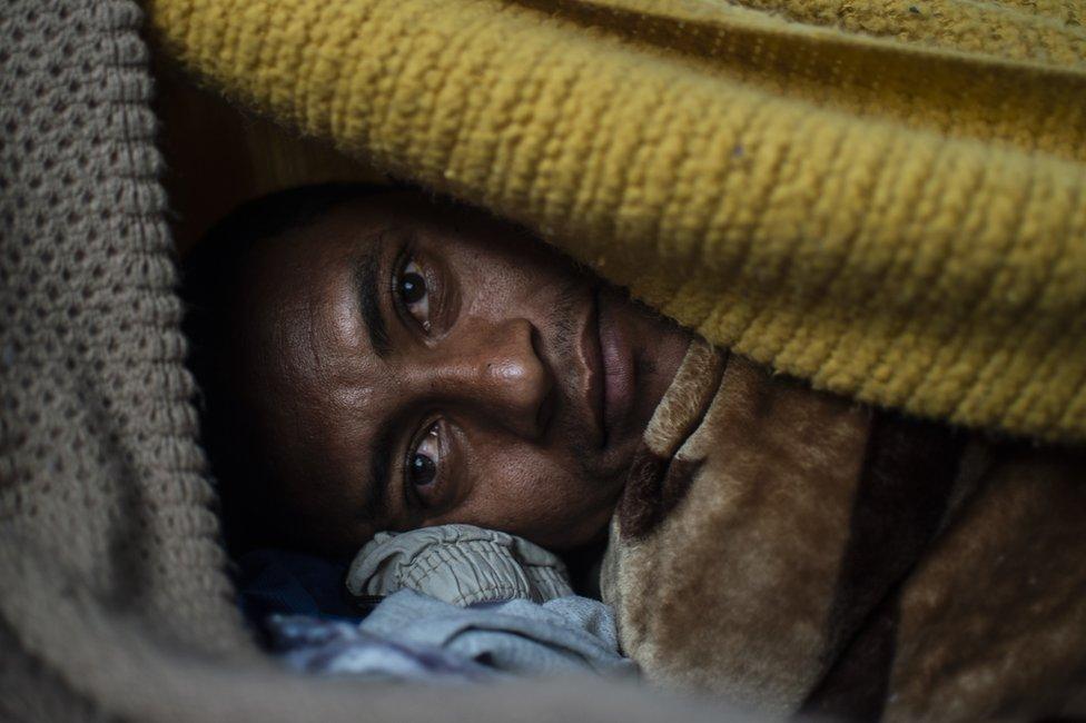 A Central American migrant rests under a bridge near El Chaparral port of entry at the US-Mexico border in Tijuana, Baja California state, Mexico, 23 November