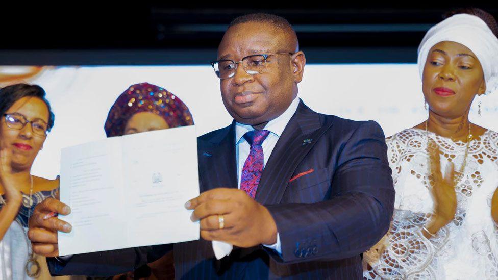 First Lady Fatima Bio (R) watches her husband hold up the he Prohibition of Child Marriage Act 