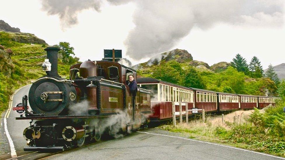 Full steam ahead: The Blaenau Ffestiniog narrow gauge train steams over the level crossing at Tanygrisiau on its journey to Porthmadog