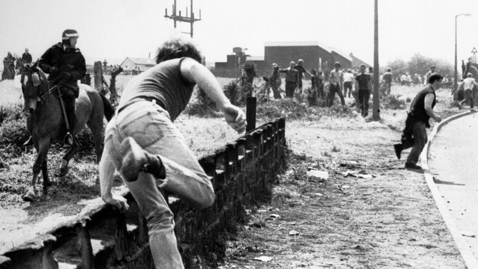 Miners running away from police horse