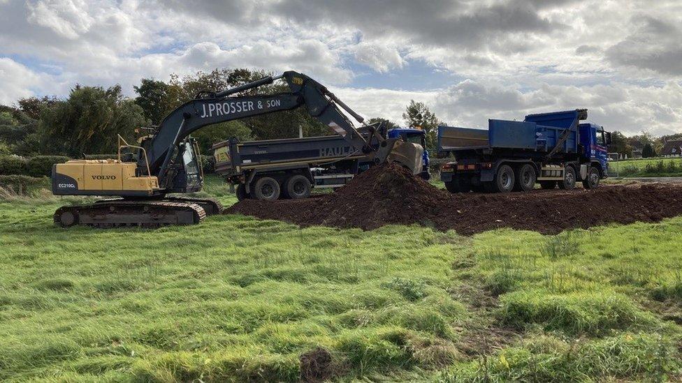 digger bringing materials