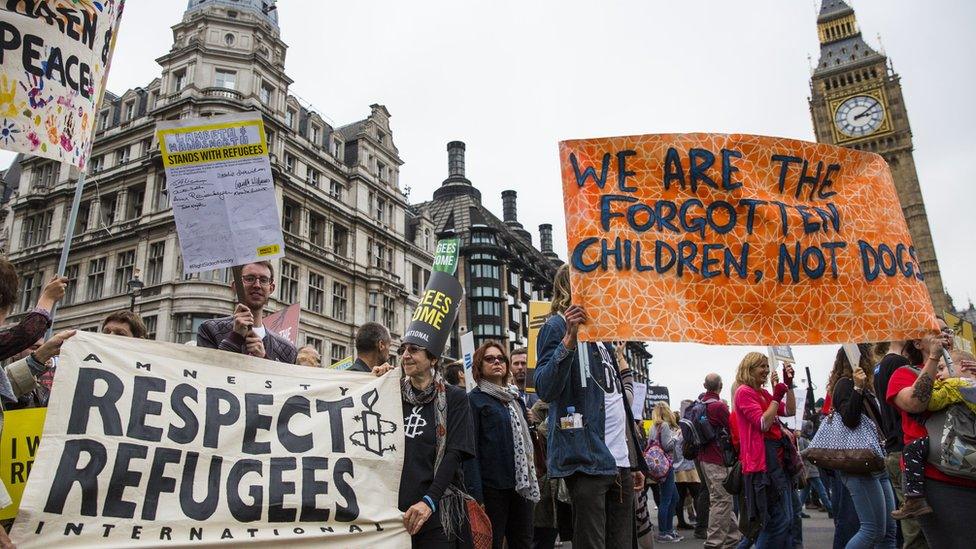 Demonstrators holding banners as they march towards Parliament Square.