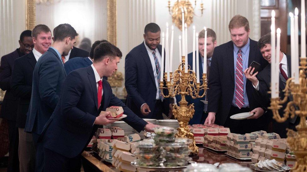 Guests select fast food that the US president purchased for a ceremony honouring the 2018 College Football Playoff National Champion Clemson Tigers