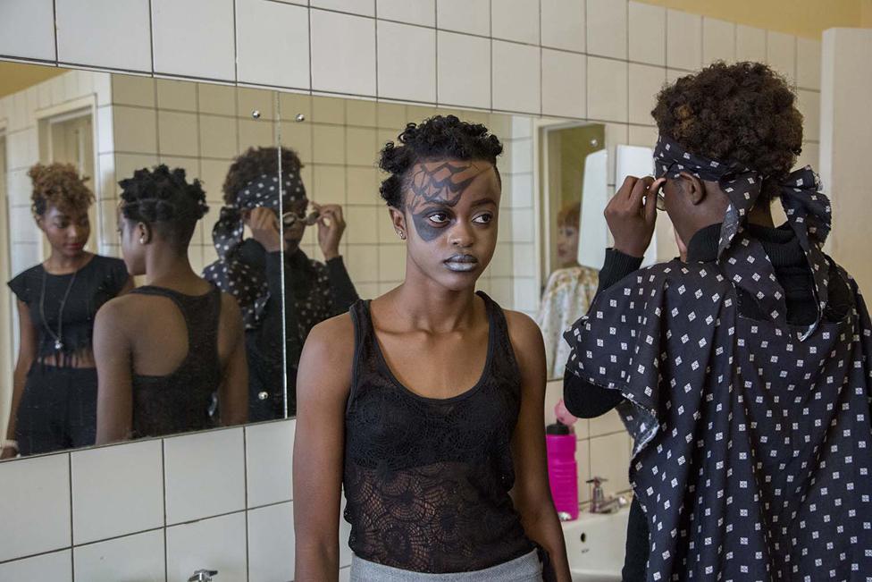 Two girls prepare back stage for a fashion show