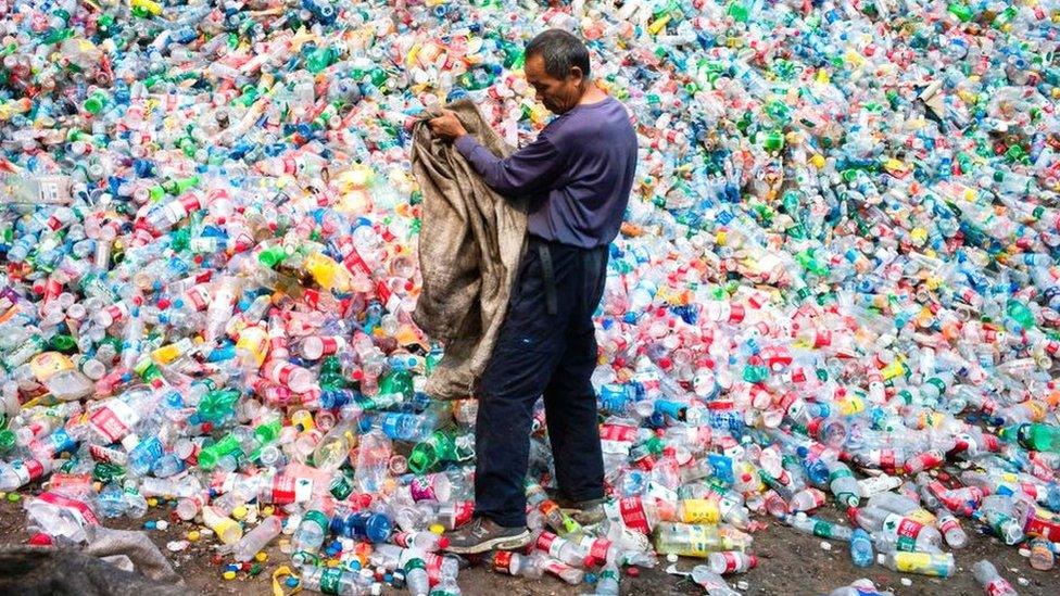 A Chinese worker sorting out plastic bottles for recycling on the outskirts of Beijing.