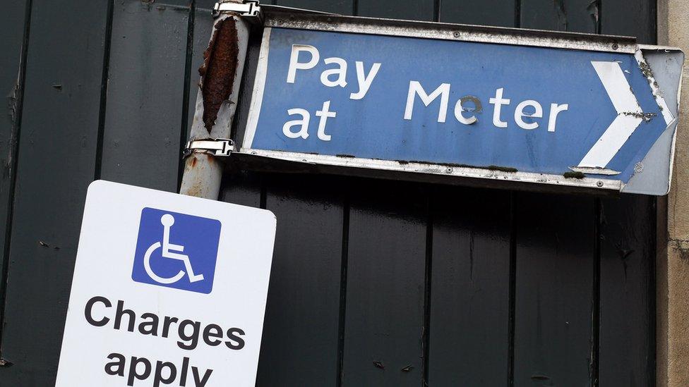 A sign above a disabled car parking bay