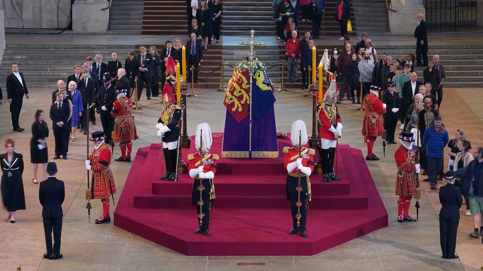 The first members of the public pay their respects as the vigil begins around the coffin of Queen Elizabeth II in Westminster Hall, London,