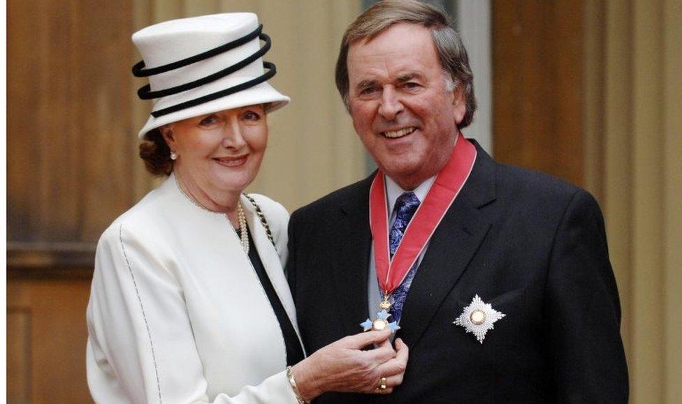 Sir Terry Wogan with his wife Lady Helen after collecting his knighthood from Queen Elizabeth II in 2005