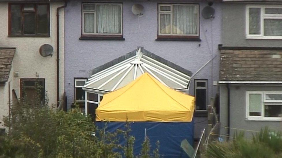 a forensic tent in the back garden of property being searched in Sunbury-on-Thames