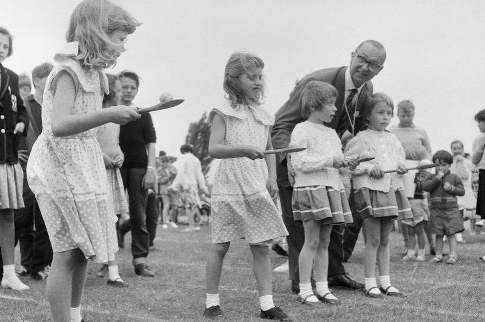 Four girls prepare for egg and spoon race