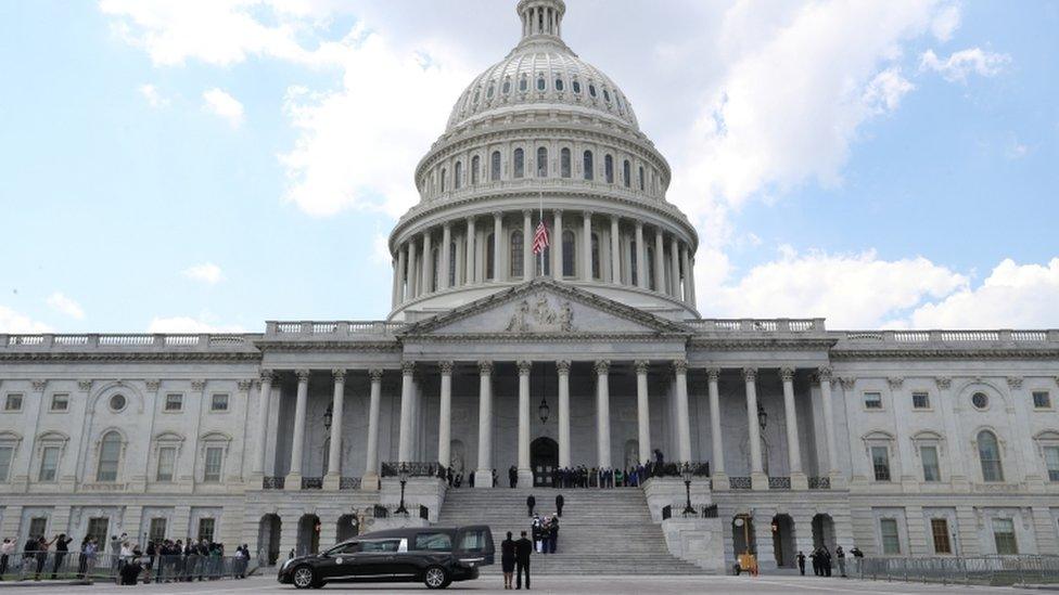 A US. military honour guard carries the casket of civil rights pioneer John Lewis (D-GA), who died July 17, up the steps of the US Capitol