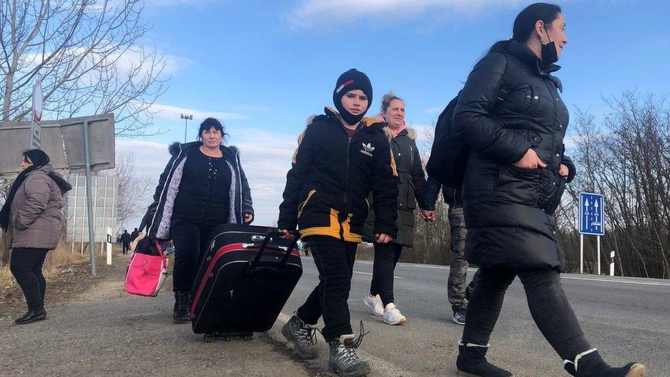 Refugees walk on foot near the Hungarian-Ukrainian border