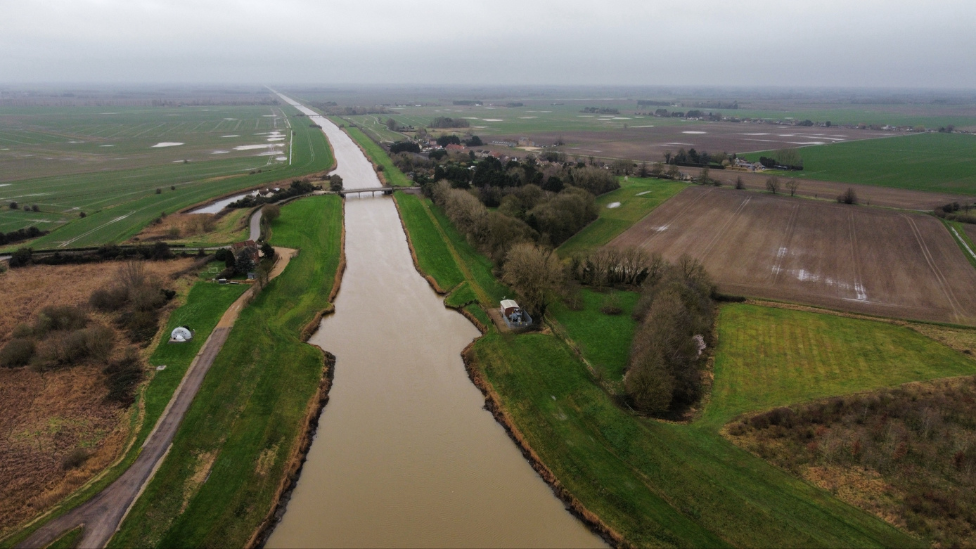 A large body of water between fields