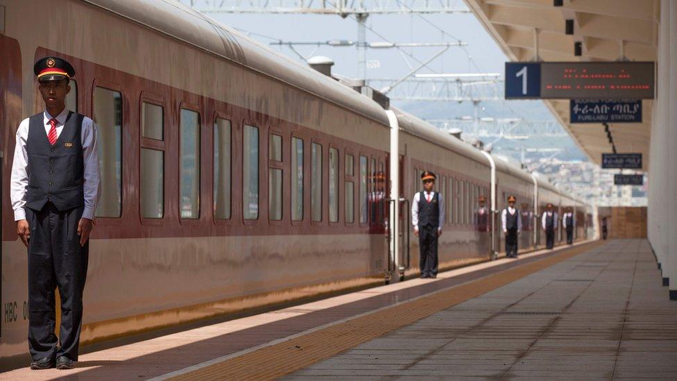 Chinese employees of the Addis Ababa / Djibouti train line stand at the Feri train station in Addis Ababa on September 24, 2016. With Chinese conductors at the helm, a fleet of shiny new trains will on October 5, 2016 begin plying a new route from the Ethiopian capital to Djibouti, in a major boost to both economies.