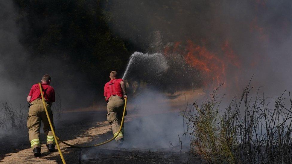 Firefighters battle a grass fire on Leyton flats in east London in August 2022