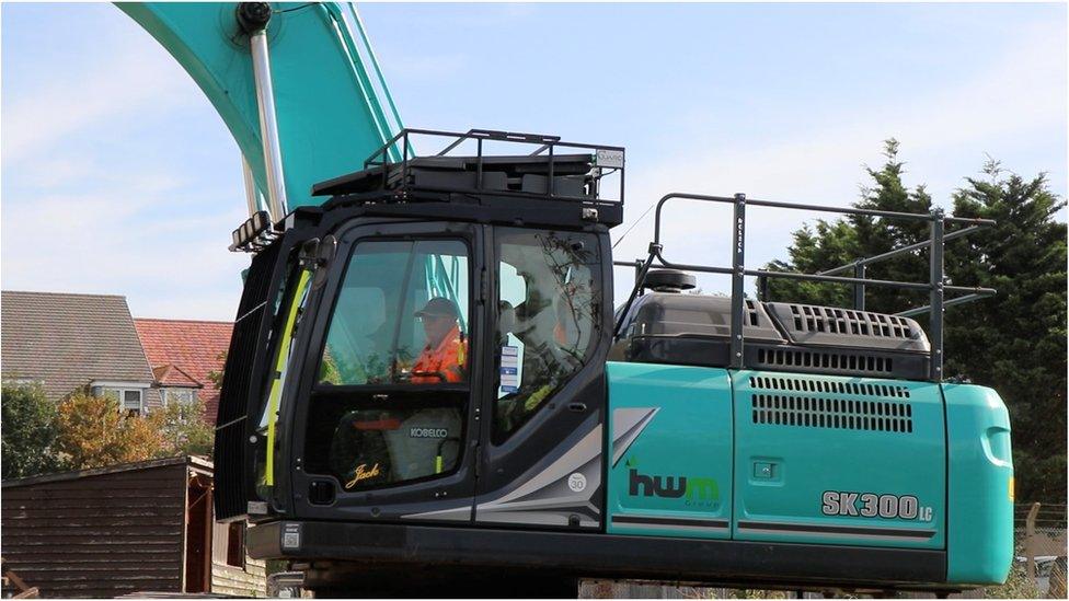 A digger being driven by Mr Butcher