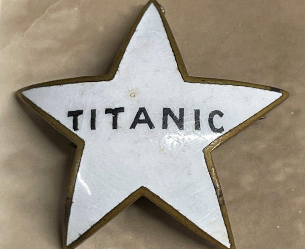 A close-up image of the White Star Line staff badge