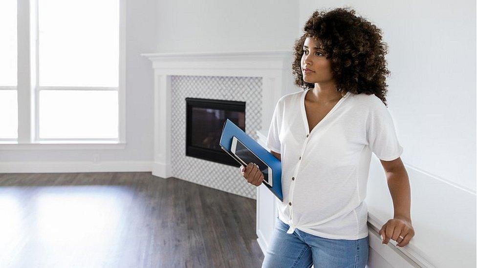 Woman in unfurnished apartment