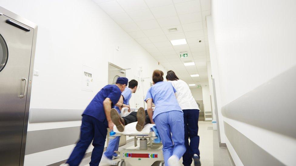 Medical staff transferring patient