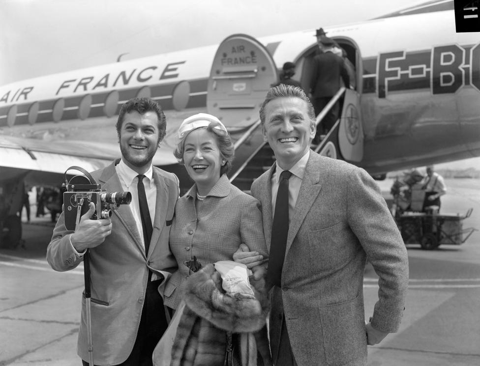 Kirk Douglas and his wife Anne being met by Tony Curtis, on their arrival at London Airport in 1957 for the film The Vikings.